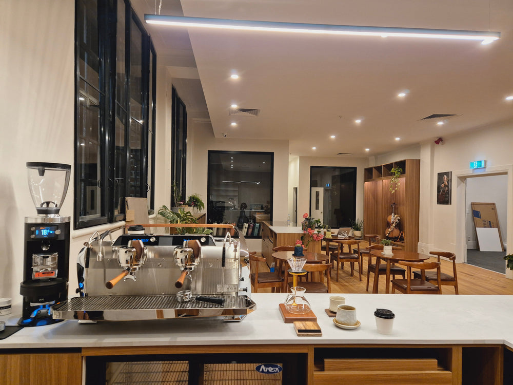 Evening view across the coffee counter and seating at Symphonia Café