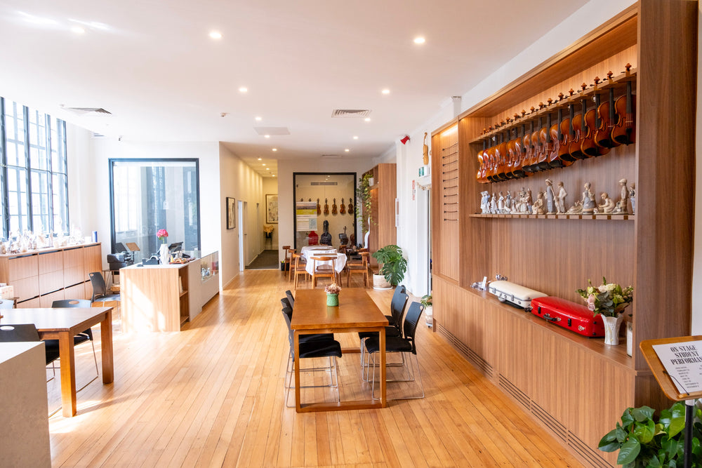 Symphonia Café interior with wooden tables and a violin display