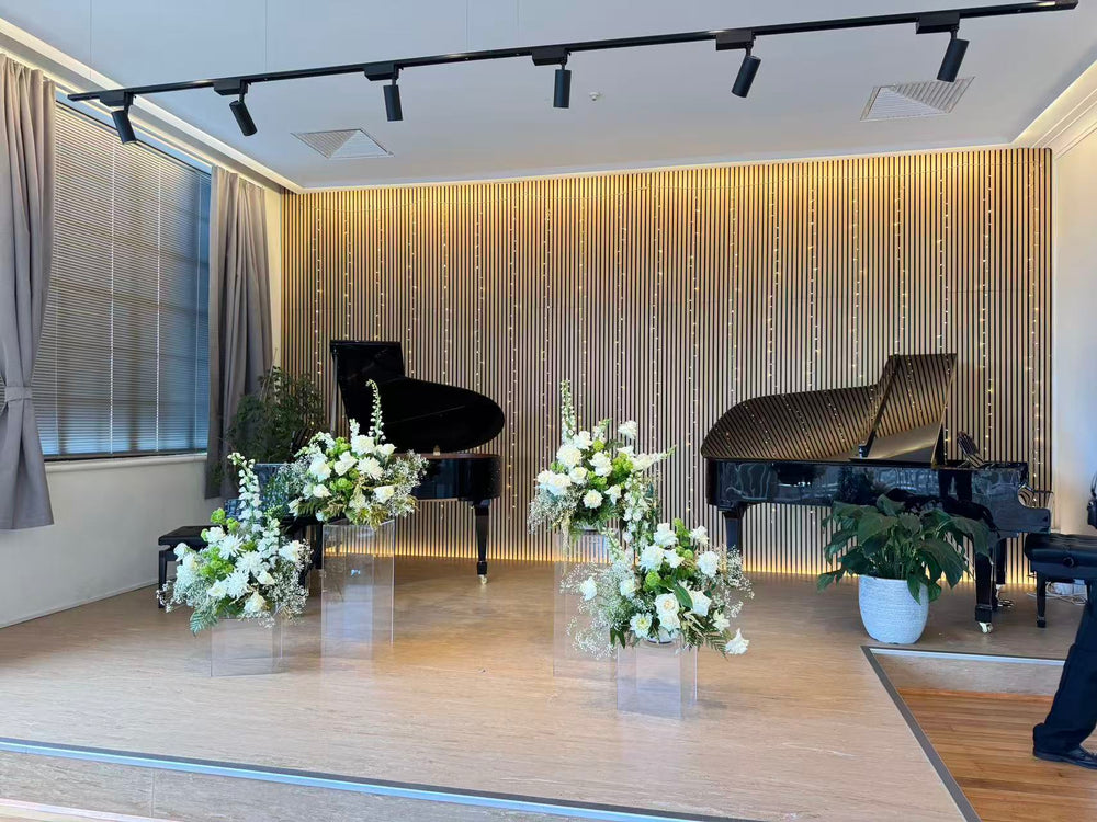 Grand pianos and floral arrangements on the Symphonia Hall stage