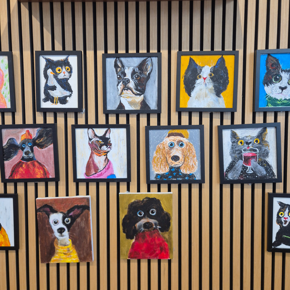 Framed animal portraits displayed at Symphonia