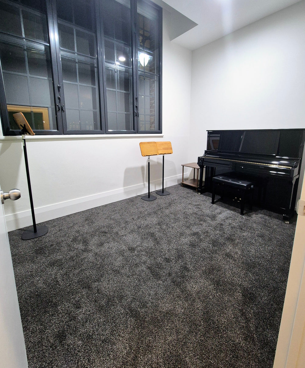 Practice room 2 with an upright piano and music stand