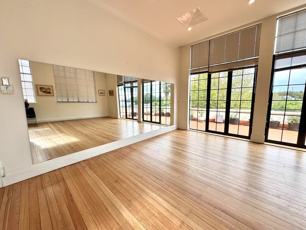 Open wooden floor, mirrored wall and terrace doors at Symphonia Hall