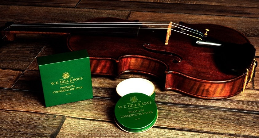 Conservation Wax being applied to a violin