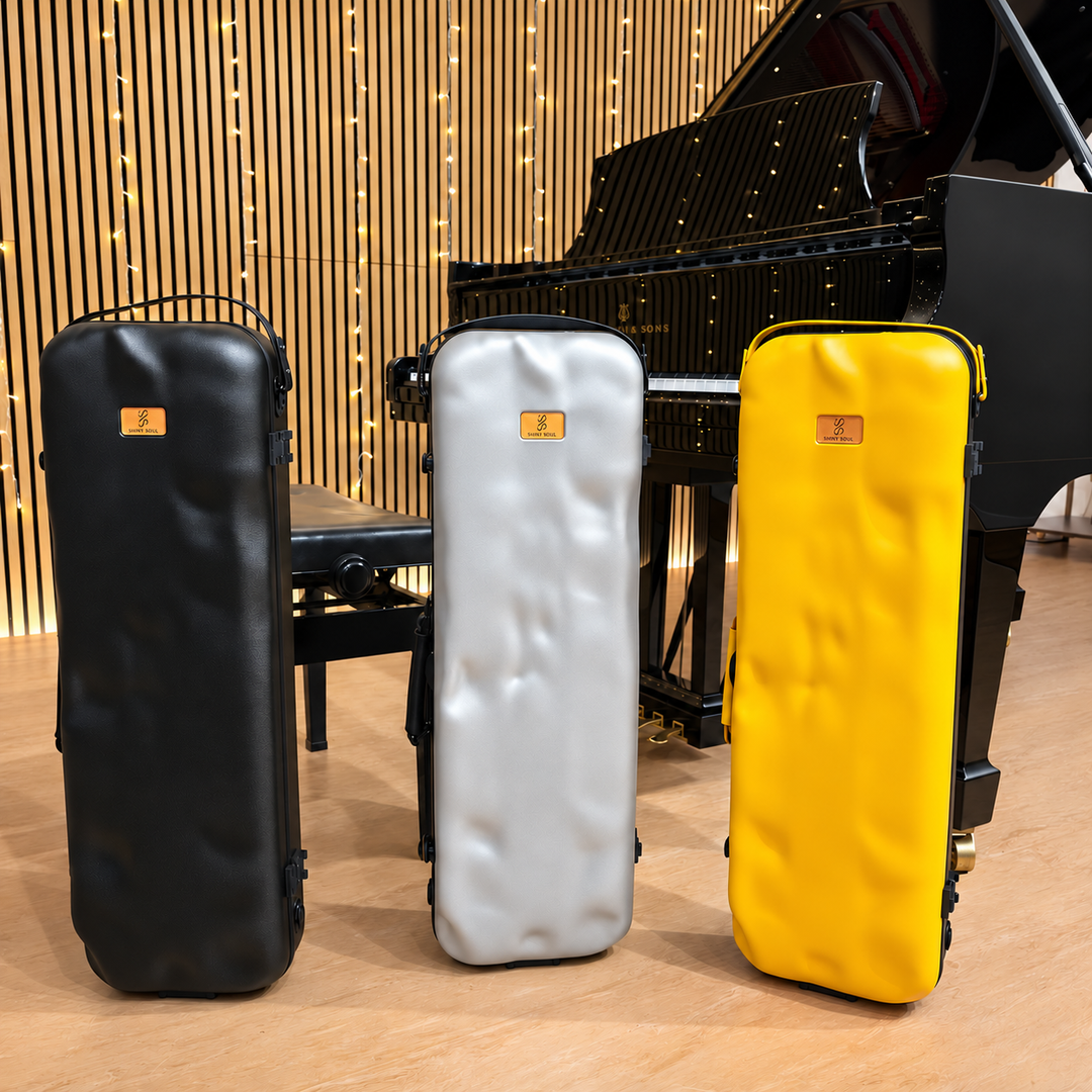 Black, Grey and Yellow Show Soul violin cases together in front of a grand piano