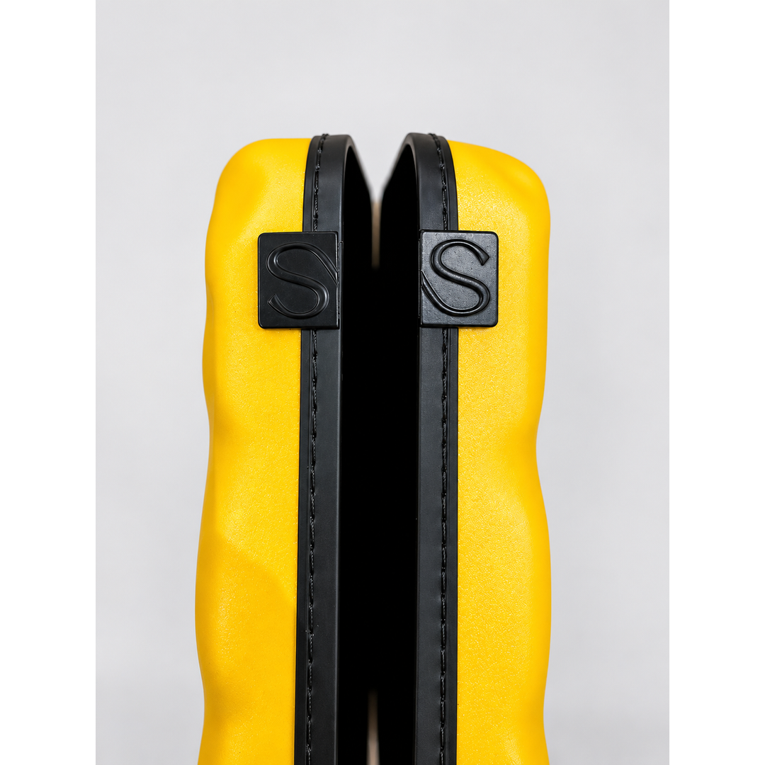Close-up of yellow Show Soul violin case shell edges and S-marked tabs