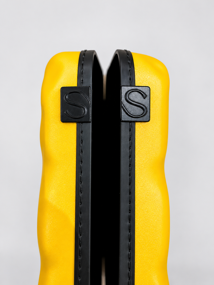 Close-up of yellow Show Soul violin case shell edges and S-marked tabs