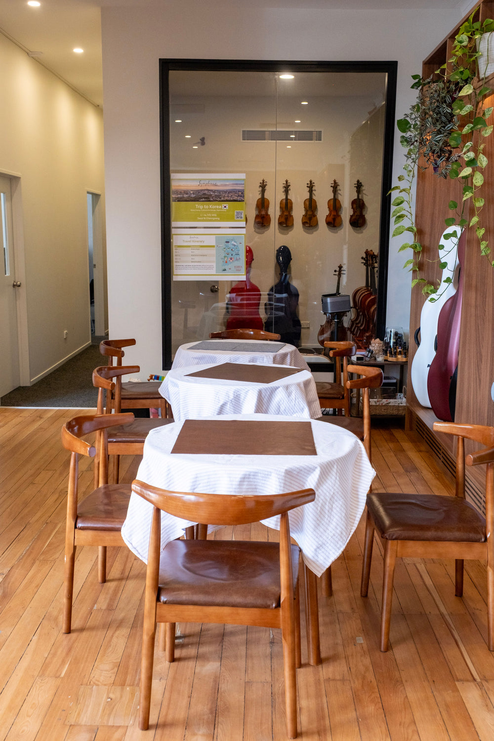 Café tables beside a display of violins