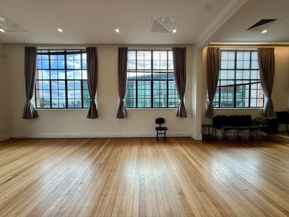 Open wooden floor and tall windows at Symphonia Hall