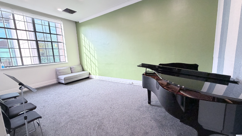 Symphonia Music Room 8 with a grand piano and seating