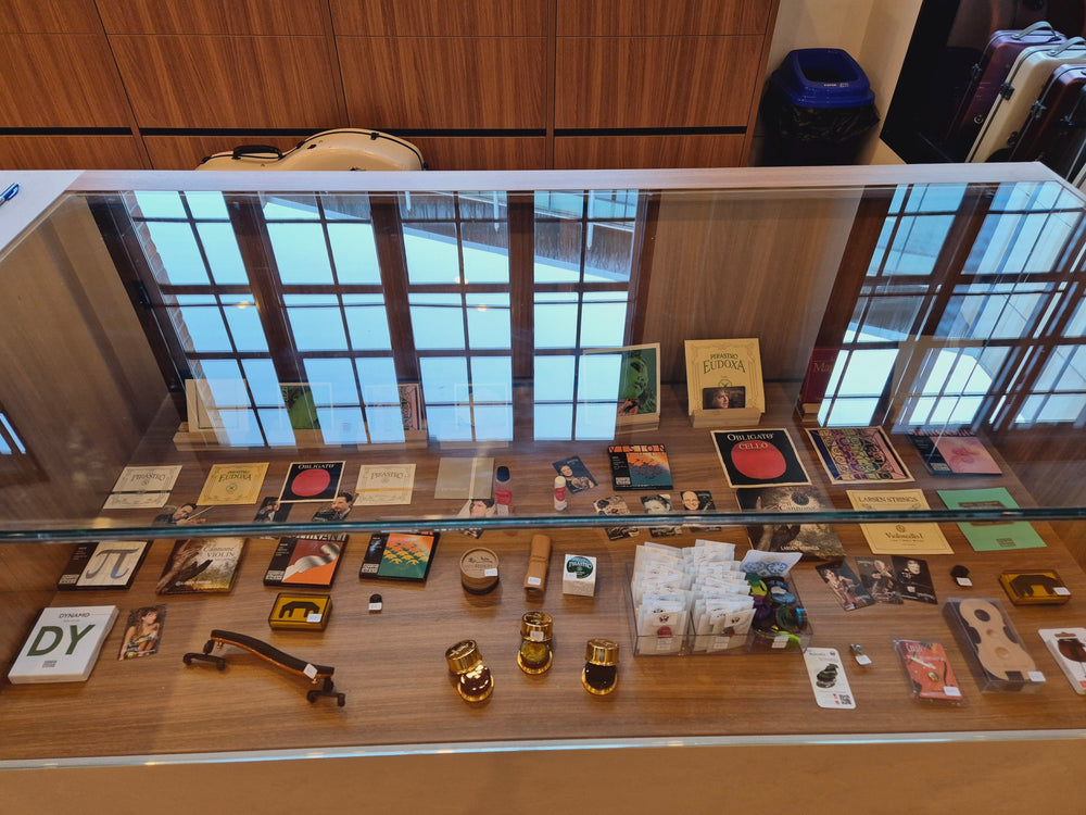 String instrument accessories arranged in a glass display cabinet