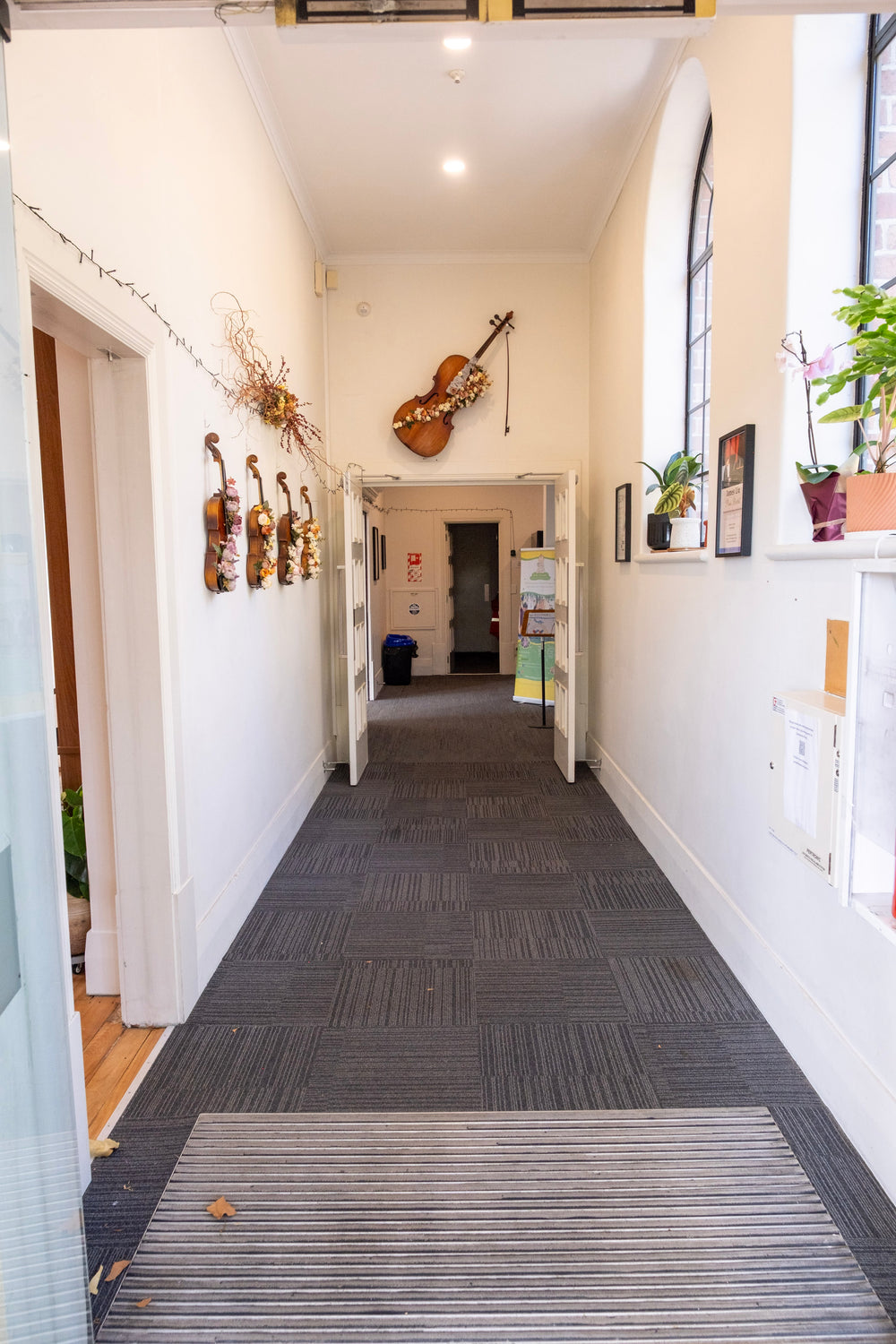 Corridor with string instruments displayed along the wall