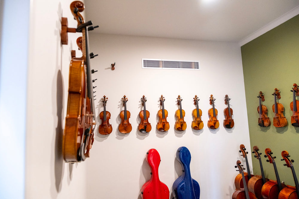 Violins, cellos and instrument cases in the Symphonia Strings showroom
