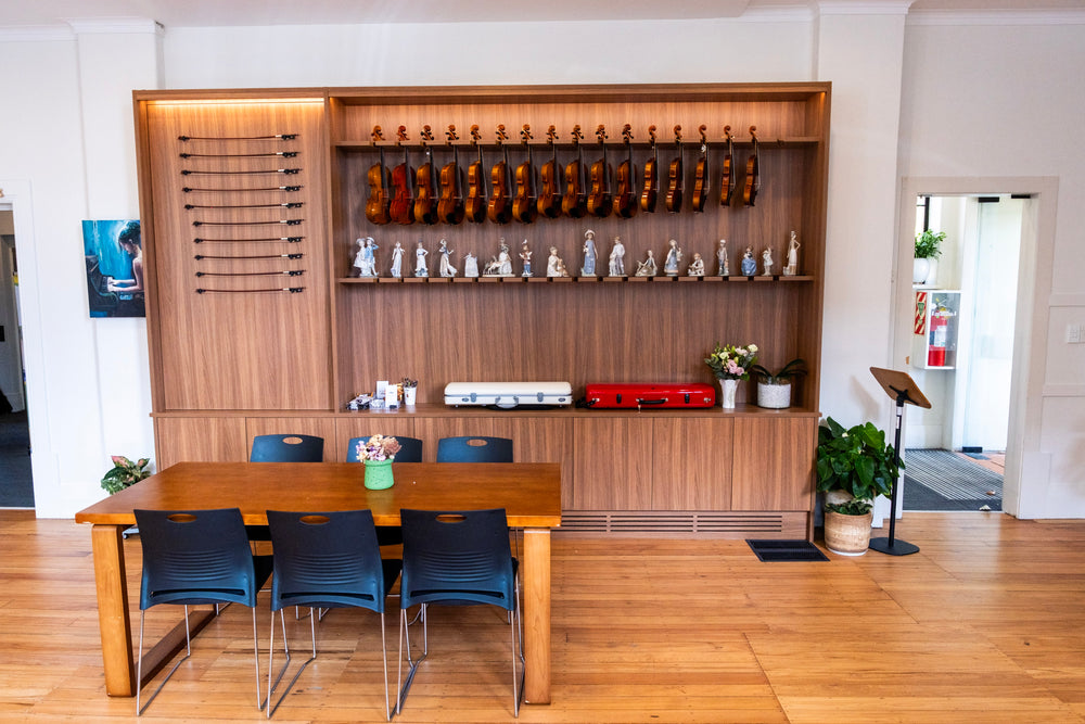 Violin display on the wooden wall at Symphonia Strings