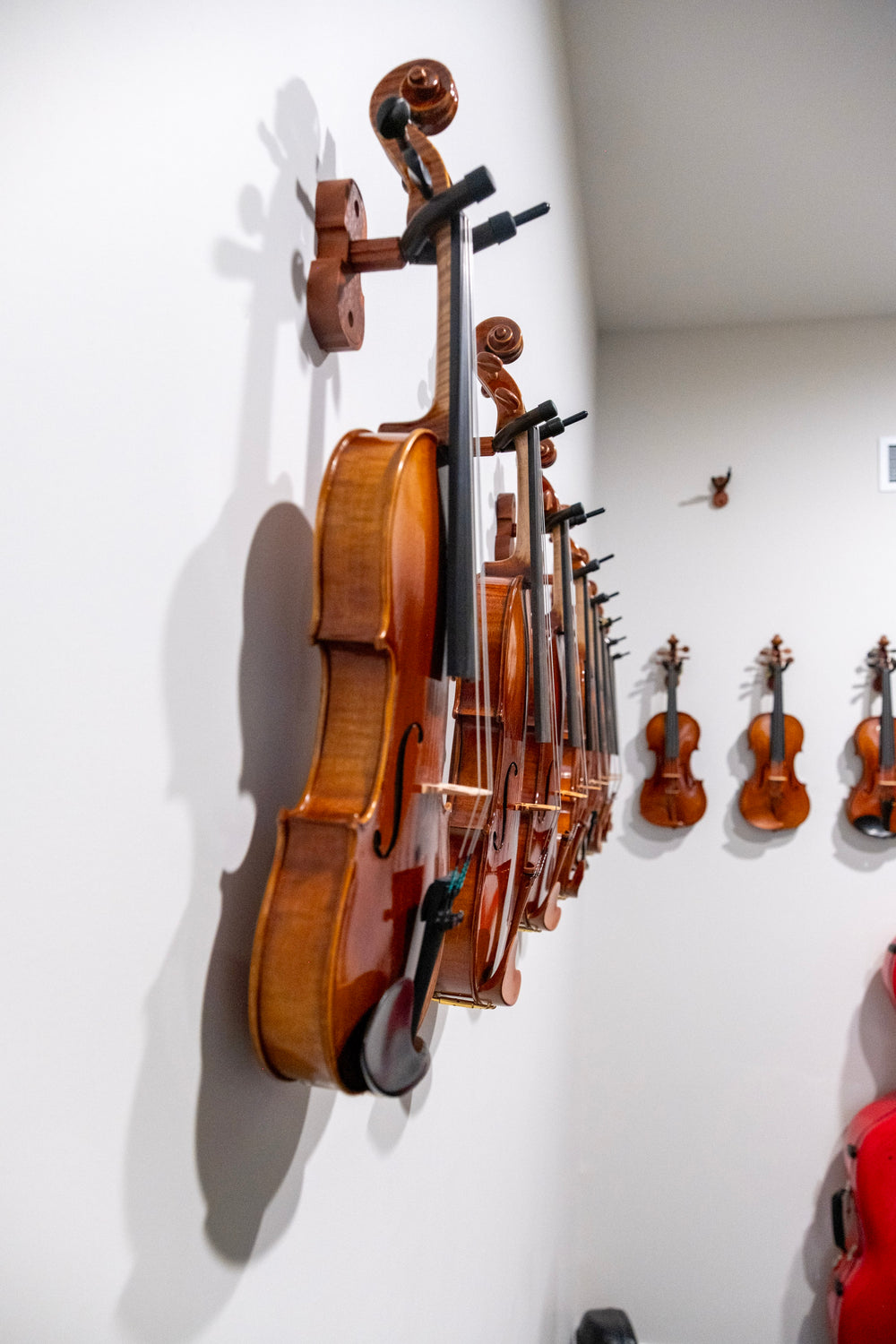Side view of violins displayed at Symphonia Strings